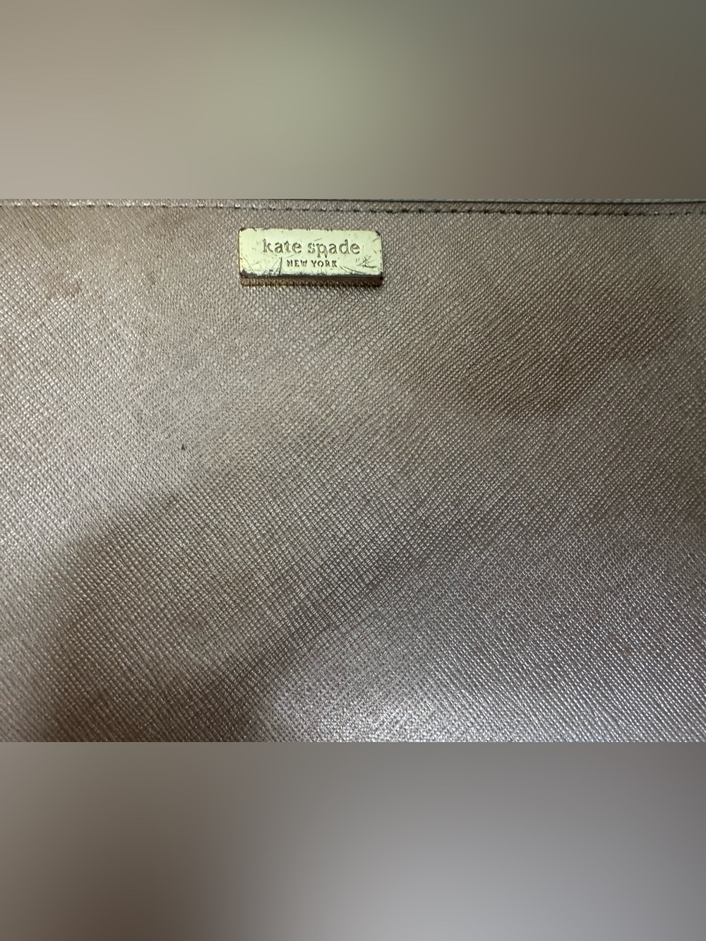 kate spade metallic taupe textured wristlet with gold logo (Project)